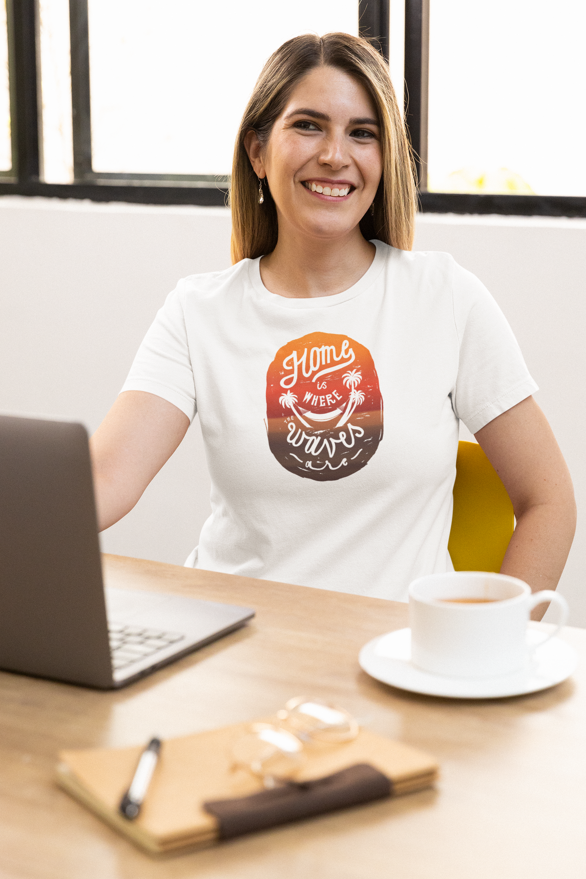 'Home Is Where Waves Are' t-shirt in white, woman wearing it at an office desk, T-Shirt mockup, Geekpsters