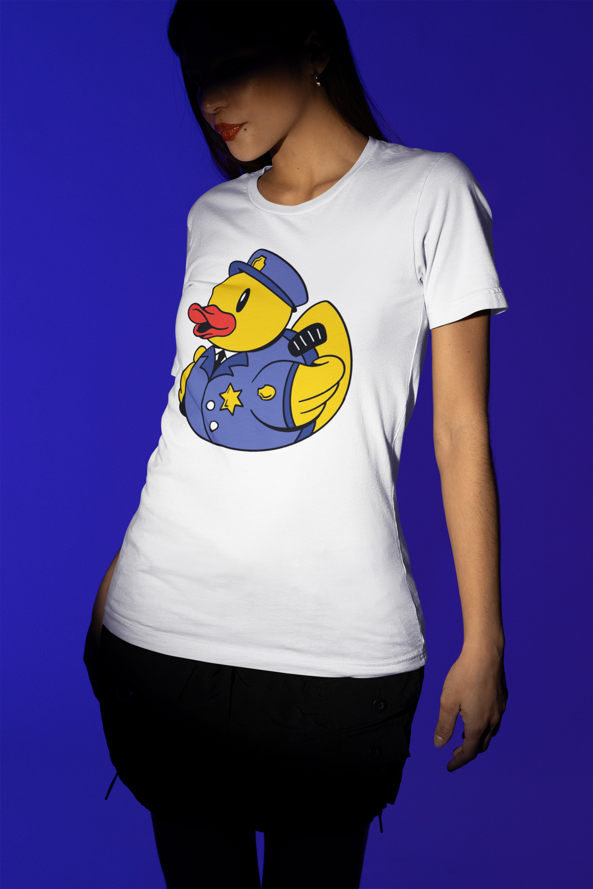 Police officer duck t-shirt in white, woman model wearing it against a blue background, funny cop duck gift