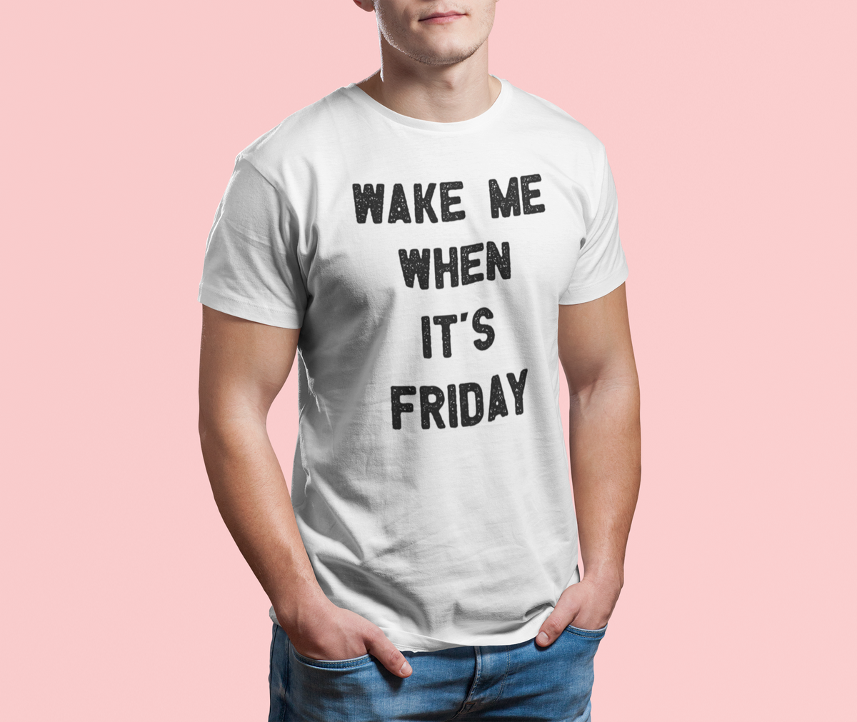"Wake Me When It's Friday" t-shirt in white, man wearing it on pink backdrop, funny weekend gift for him