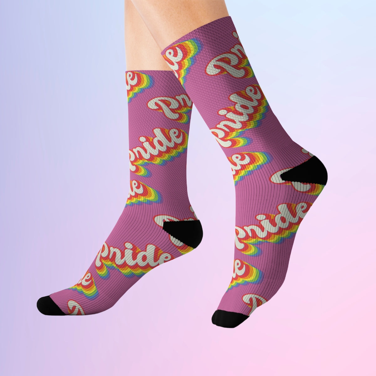 A pair of comfortable pink Pride Socks with the word pride sublimated on them.