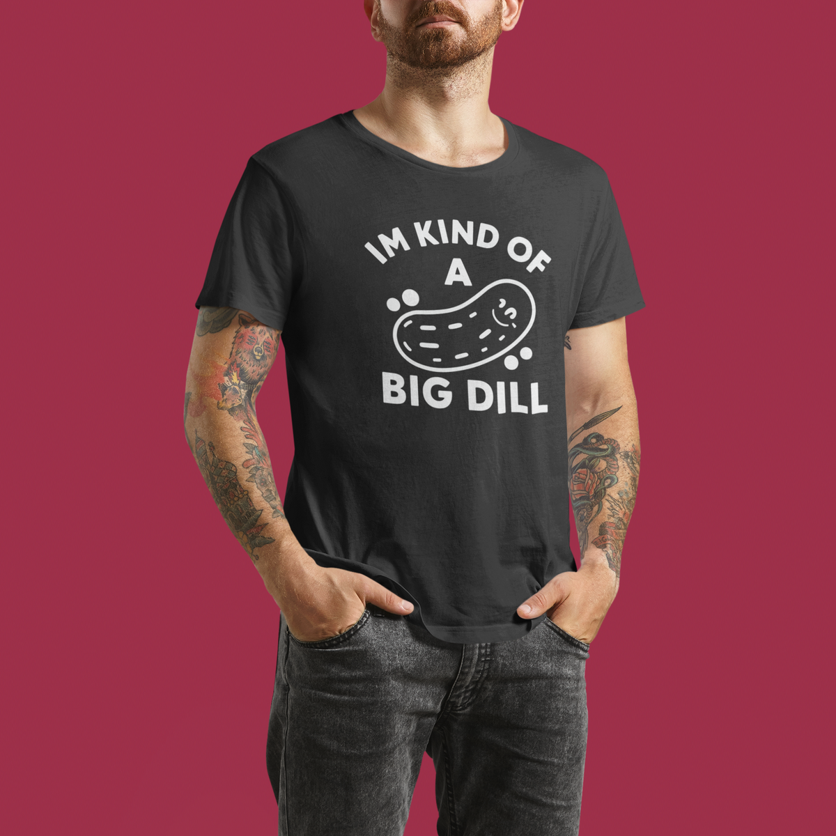'I'm Kind of a Big Dill' t-shirt in black, man wearing it against a maroon backdrop, funny pickle gift