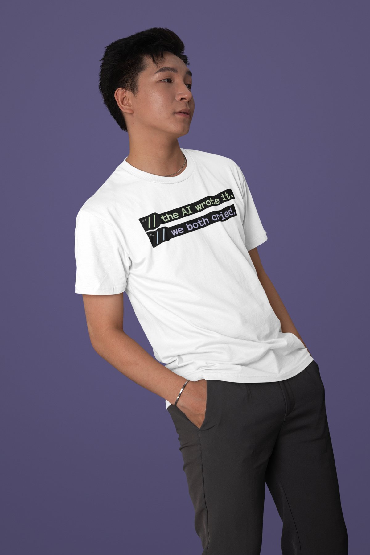 'The AI wrote it. We both cried.' white tee worn by man on purple backdrop, funny developer gift