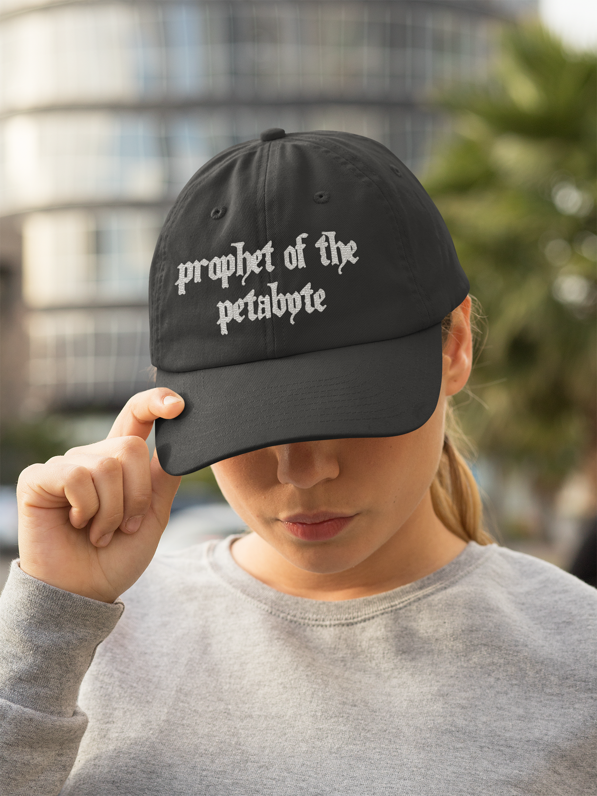 'Prophet of the Petabyte' dad hat in black, woman wearing it outdoors, funny gift for data nerds