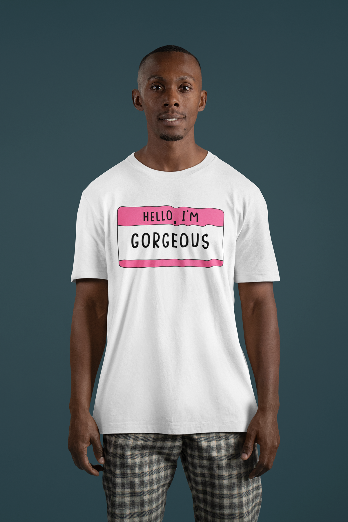 Hello I'm Gorgeous name tag T-shirt in white, man wearing it against a dark backdrop, funny gift tee