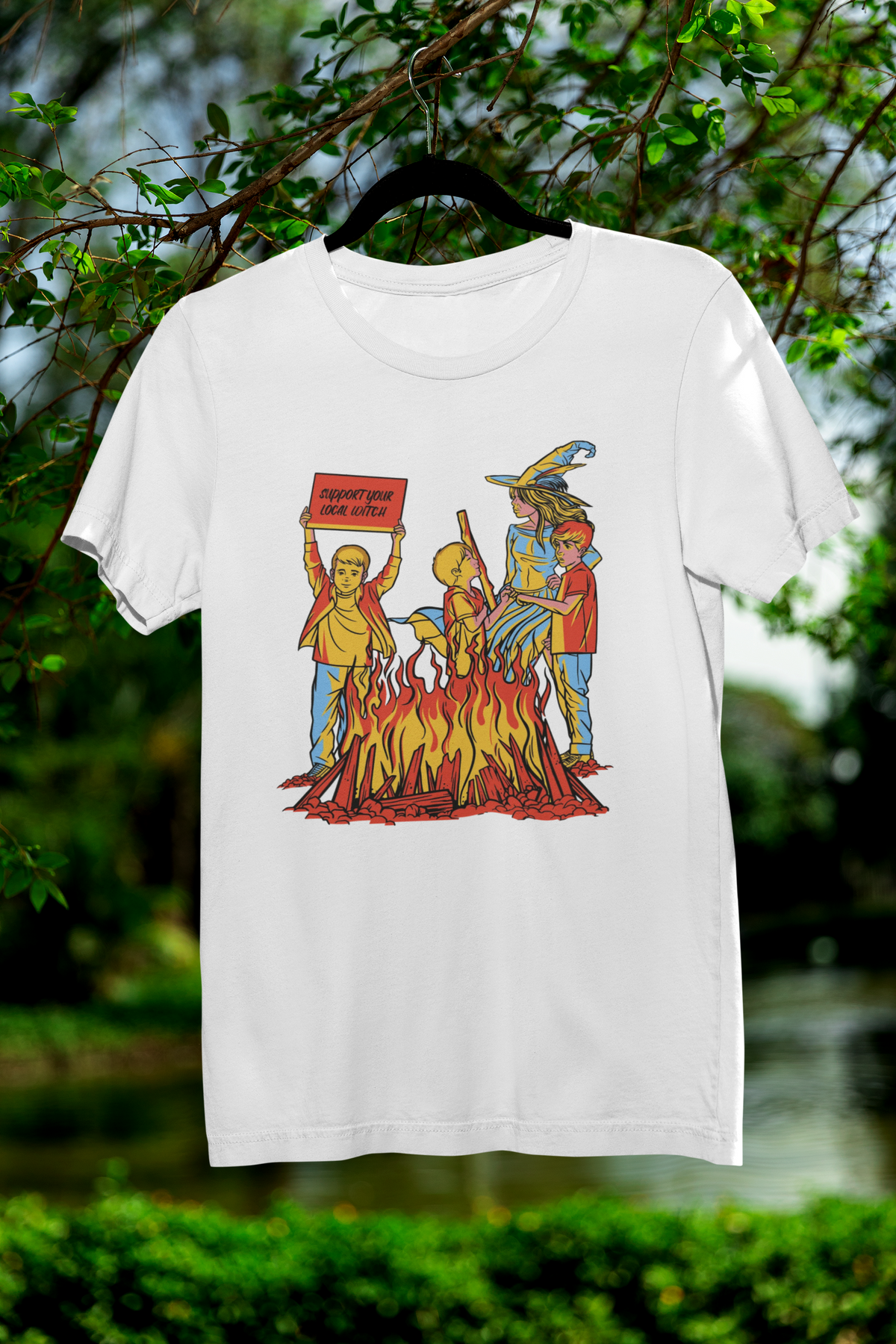 'We Love Witches' t-shirt in white, hanging outdoors, funny Halloween gift shirt