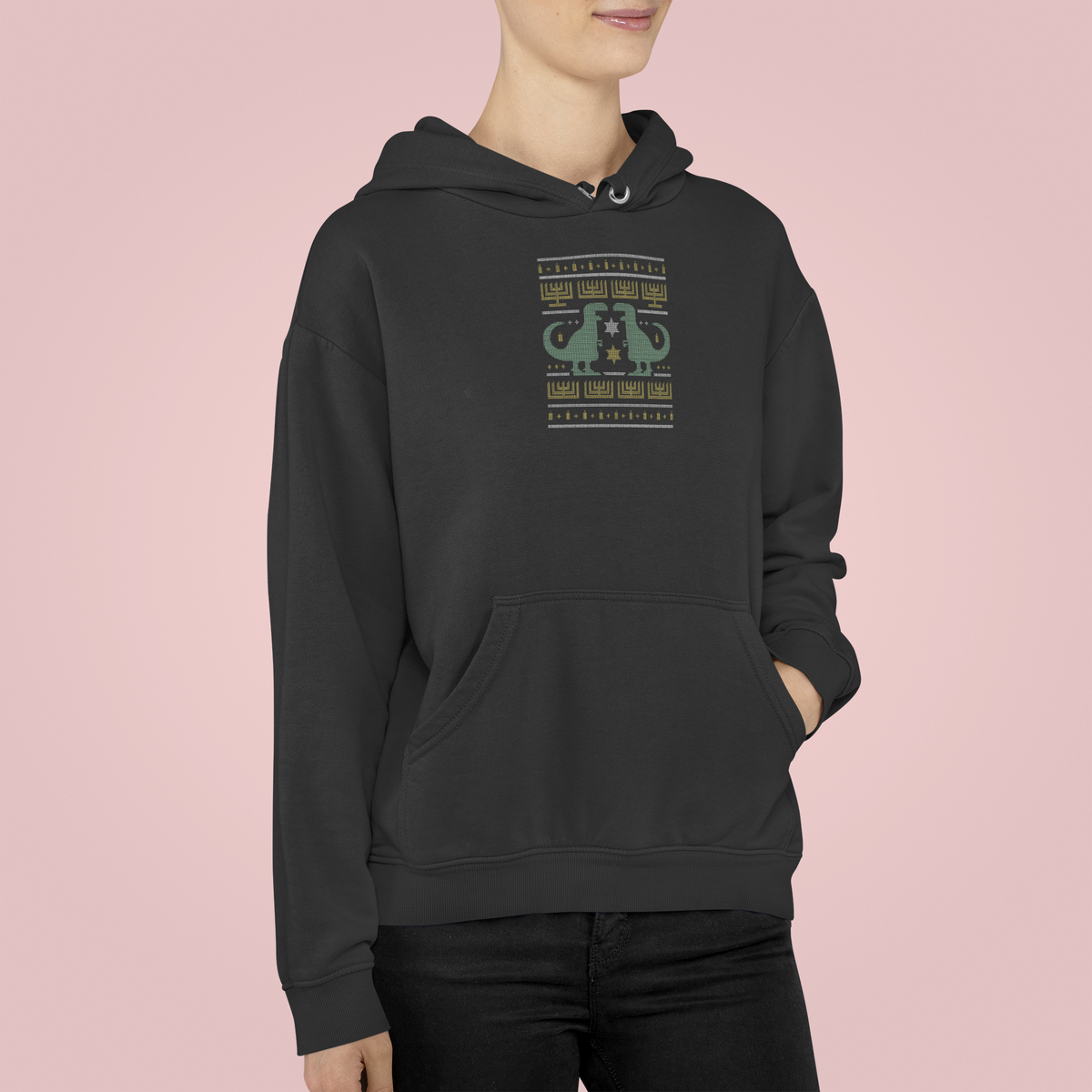 Dino Ugly Sweater Hoodie in black, woman wearing it against a pink backdrop, funny holiday gift