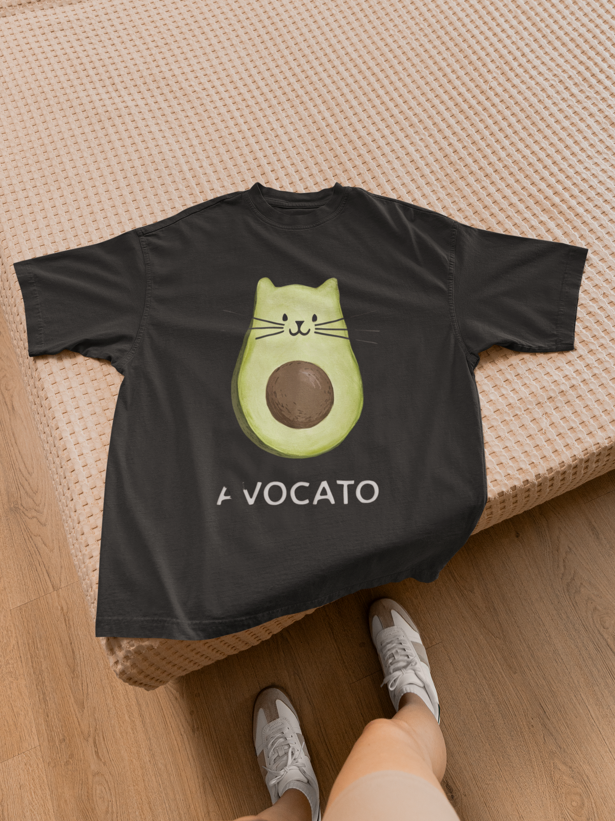 'Avocato' cat avocado t-shirt in black, flat lay on wood floor, funny gift for cat lovers