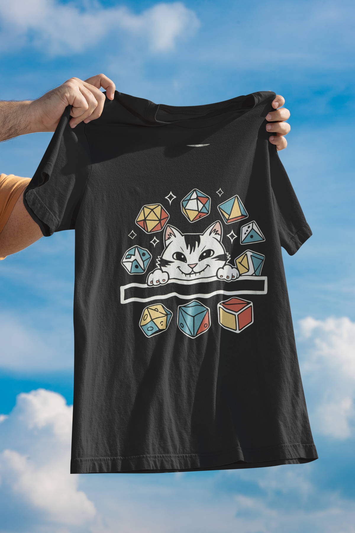 'Cat Dice' t-shirt in black, person holding it up against a blue sky, funny gamer graphic tee gift