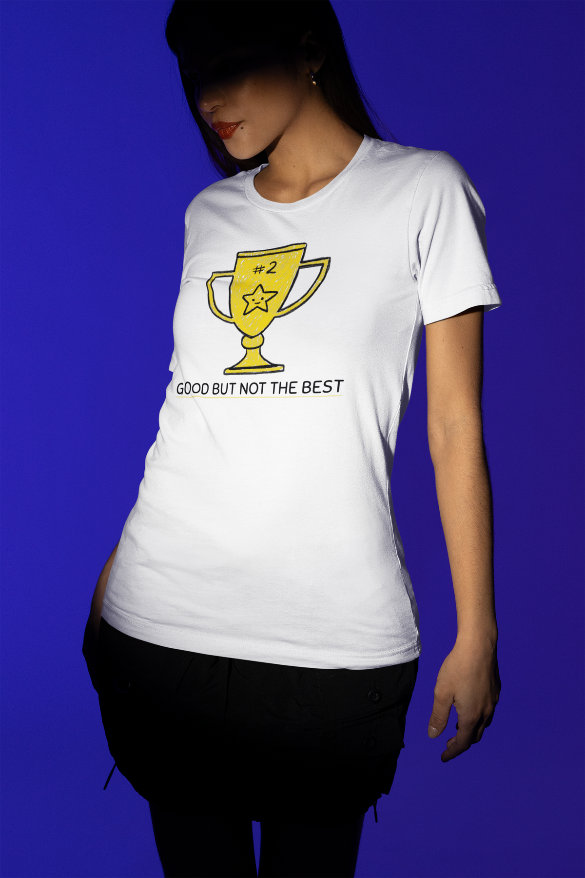 'Good But Not the Best' trophy tee in white, woman wearing it on blue backdrop, funny sarcastic tee gift