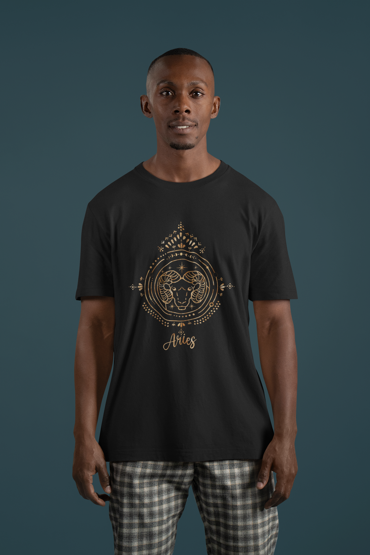 Aries zodiac T-shirt in black, man wearing it against a teal backdrop, astrology gift shirt
