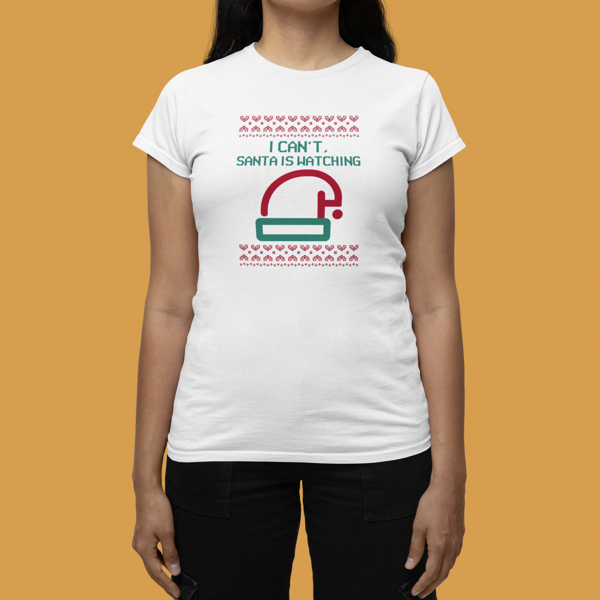 'I Can't Santa Is Watching' camera graphic tee in white, woman wearing it on orange backdrop, funny Christmas gift