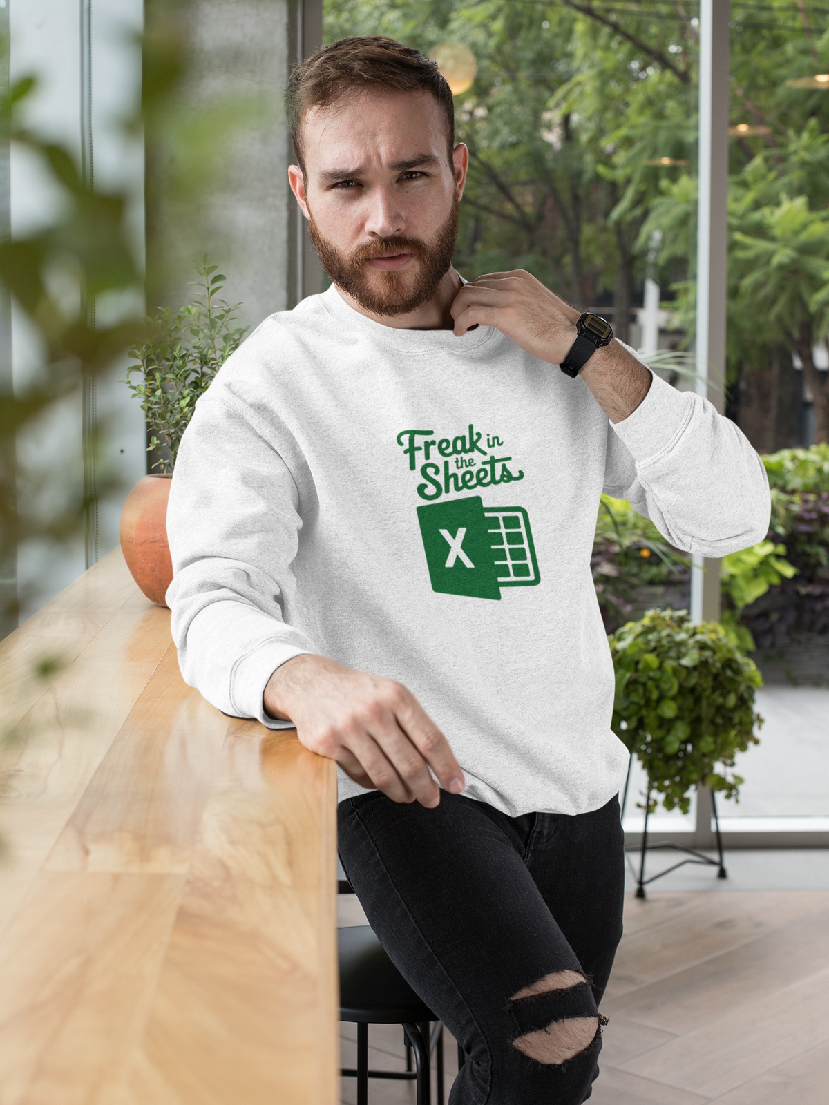 'Freak In The Sheets' sweatshirt in white, bearded man sitting indoors wearing it, funny spreadsheet gift