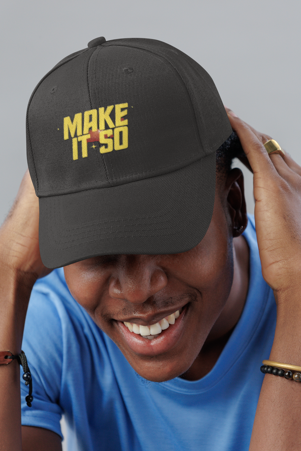 Make It So Star Trek dad hat, smiling man in a studio, lifestyle mockup, Geekpsters