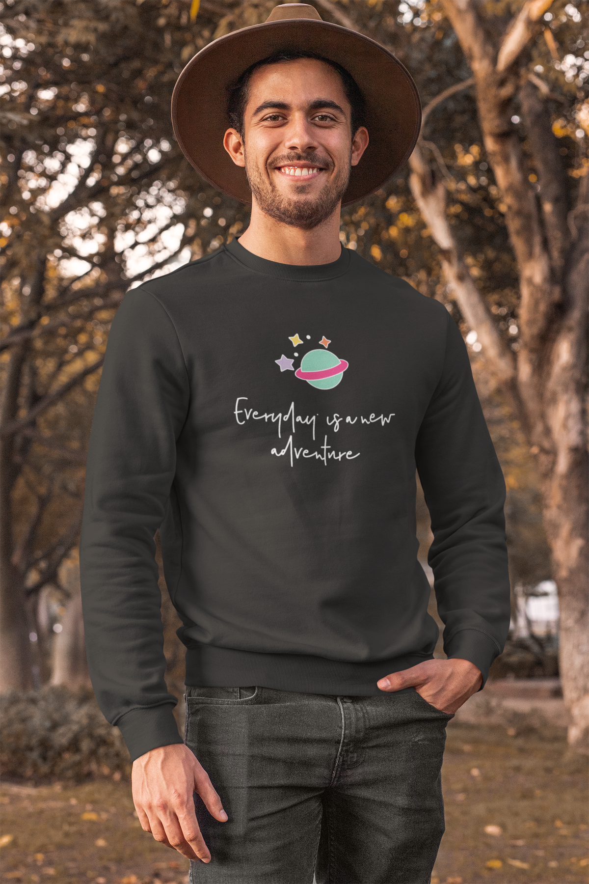 'Everyday is a New Adventure' planet sweatshirt in heather black, man wearing a hat outdoors, travel gift
