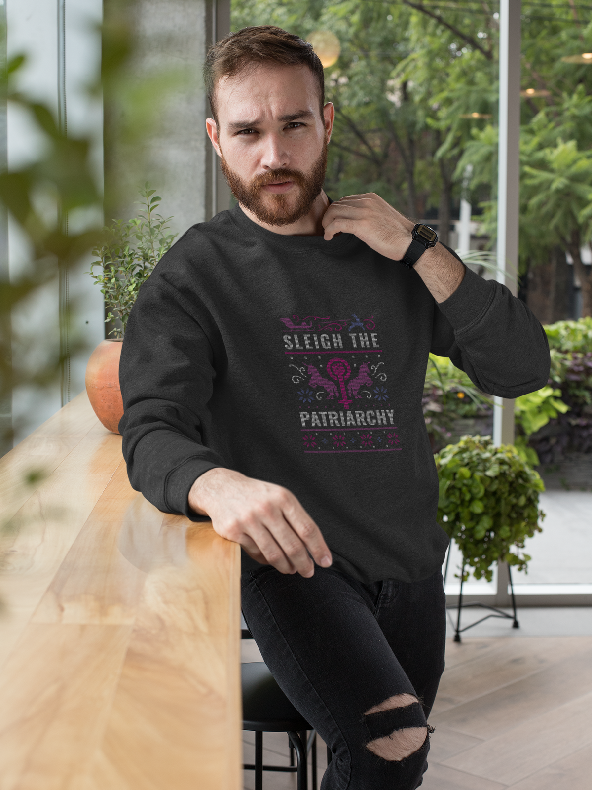 'Sleigh the Patriarchy' ugly sweater sweatshirt in black, bearded man wearing it, feminist gift