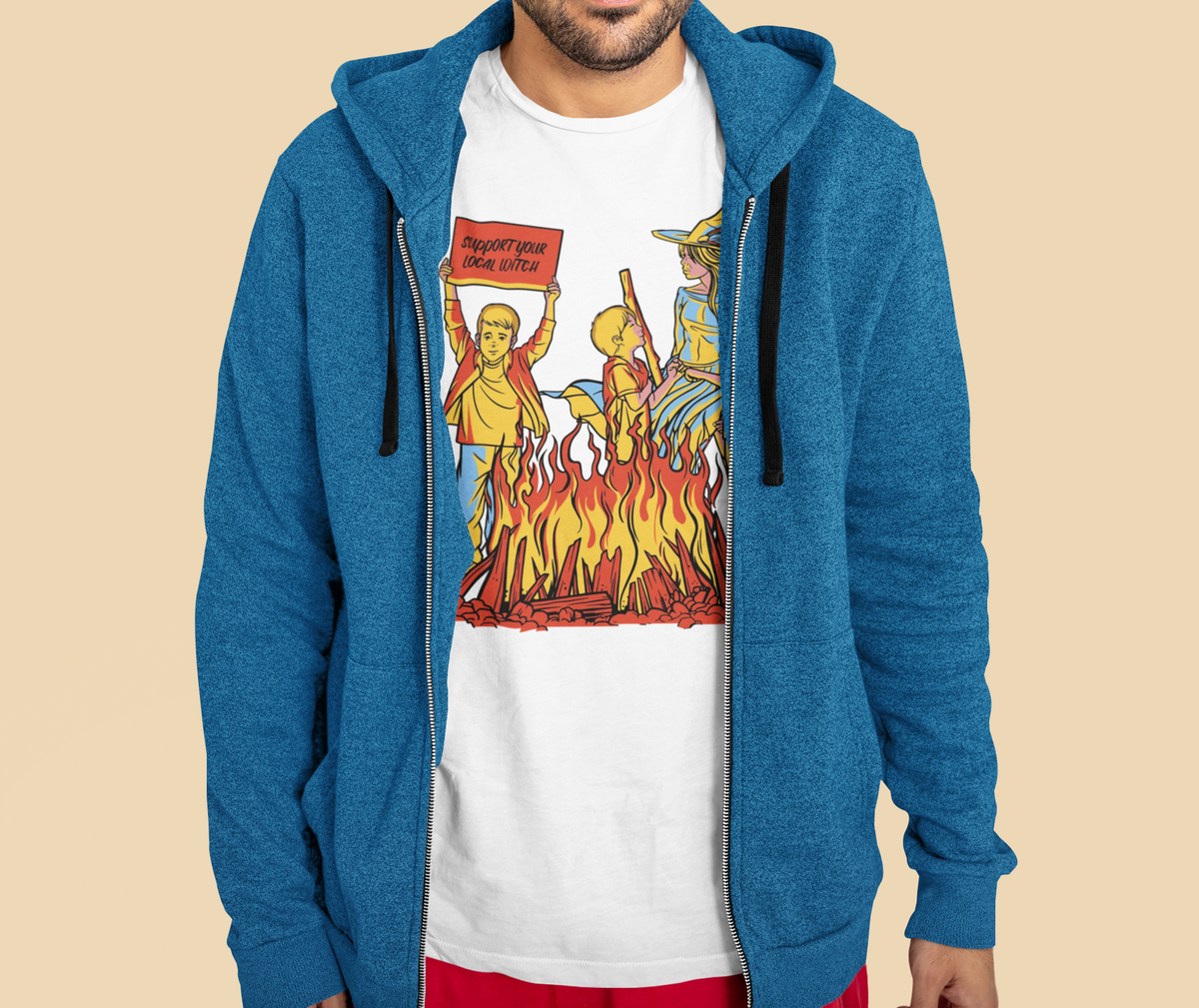 'We Love Witches' t-shirt in white, man in a blue hoodie wearing it