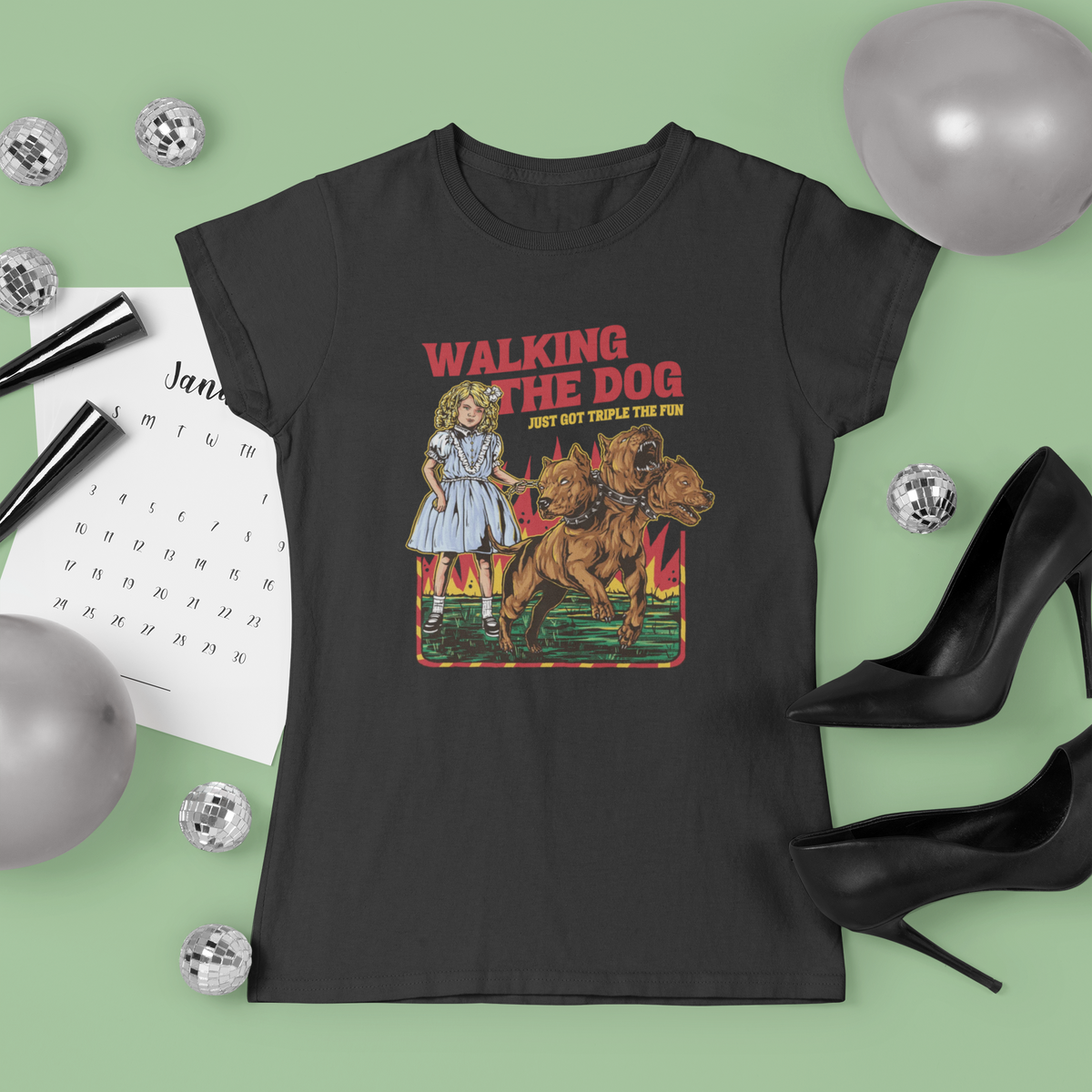 'Walking the Dog From Hell' t-shirt in black, flat lay styled with disco balls and heels, funny quirky dog gift