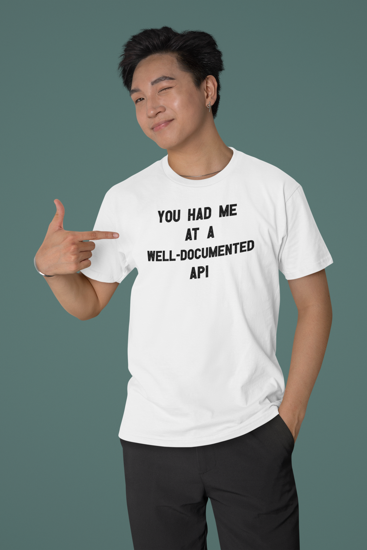 'You Had Me at a Well-Documented API' organic t-shirt in white, man pointing at it, funny coder gift