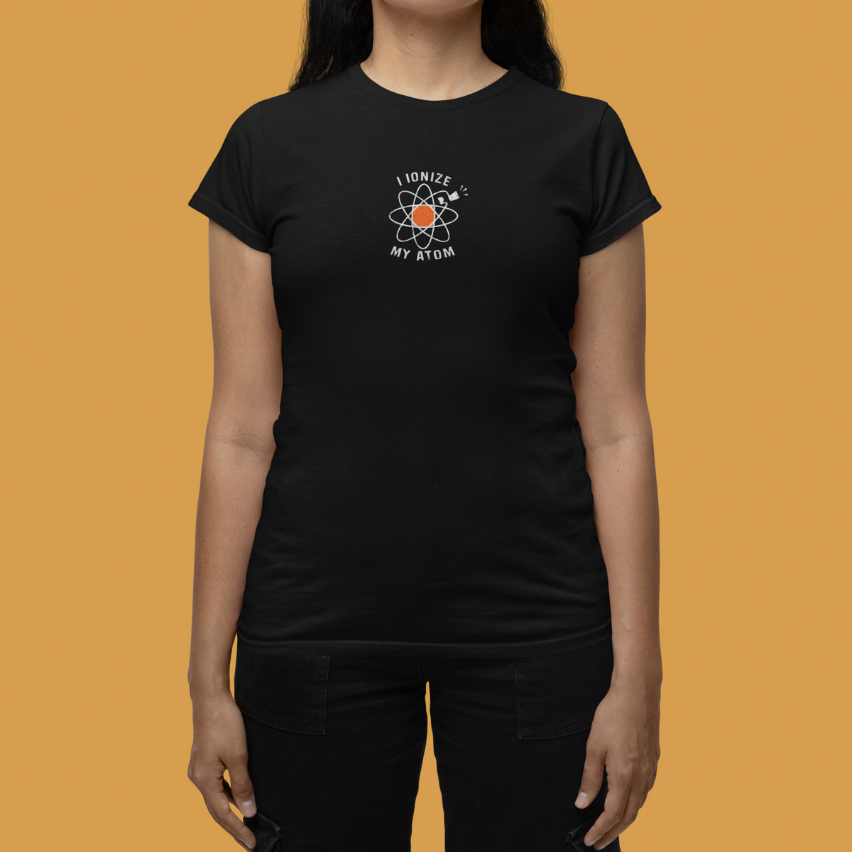 'I Ionize My Atom' womens tee in black with atom icon print, woman wearing it, funny chemistry gift