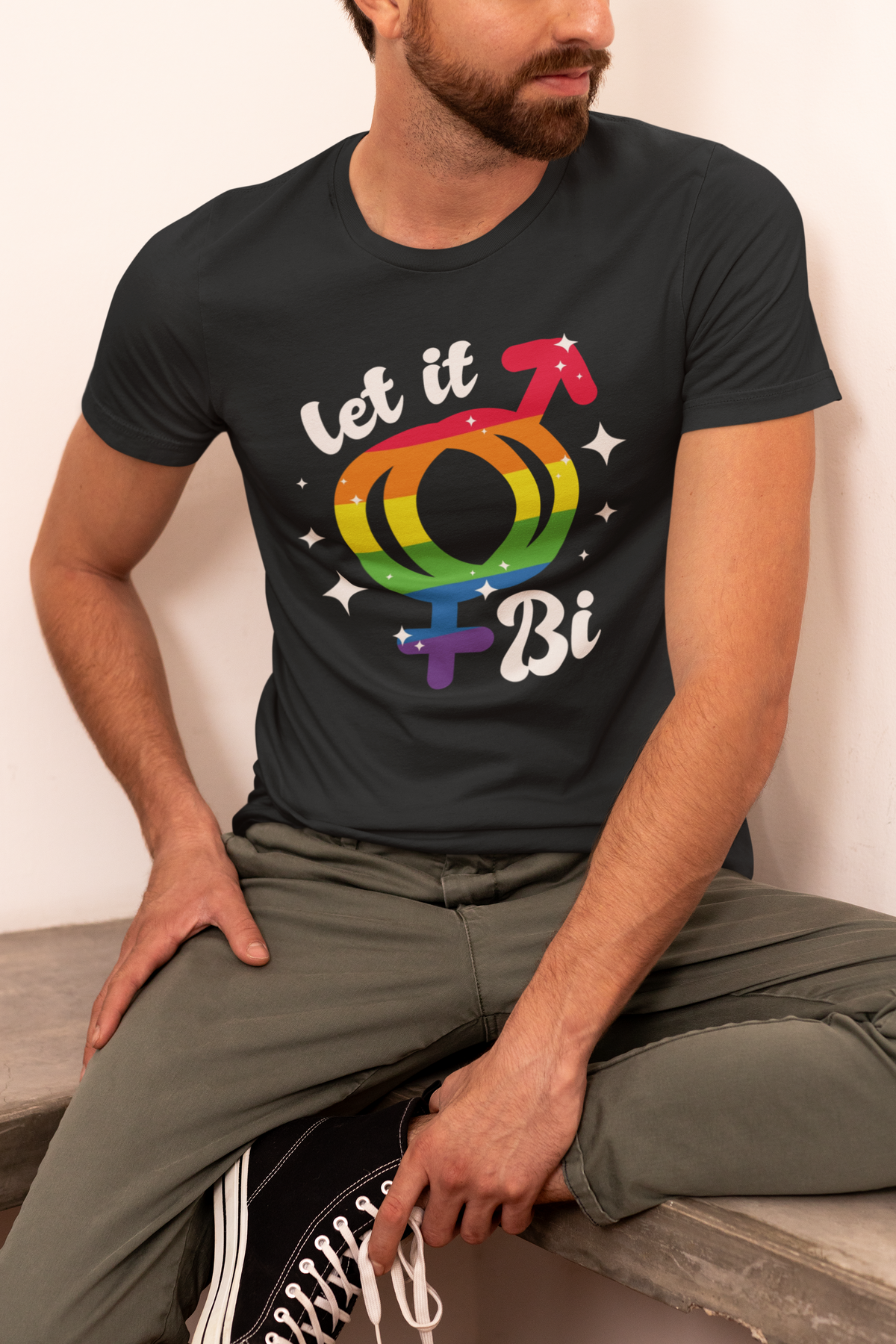 'Let It Bi' T-shirt in black, man wearing it in a studio setting, bisexual pride gift shirt