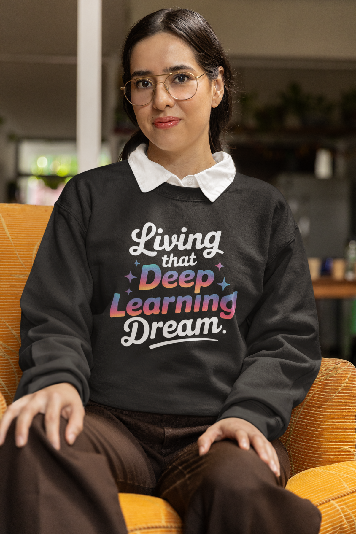 'Living that Deep Learning Dream' sweatshirt in black, woman sitting smiling indoors, developer gift