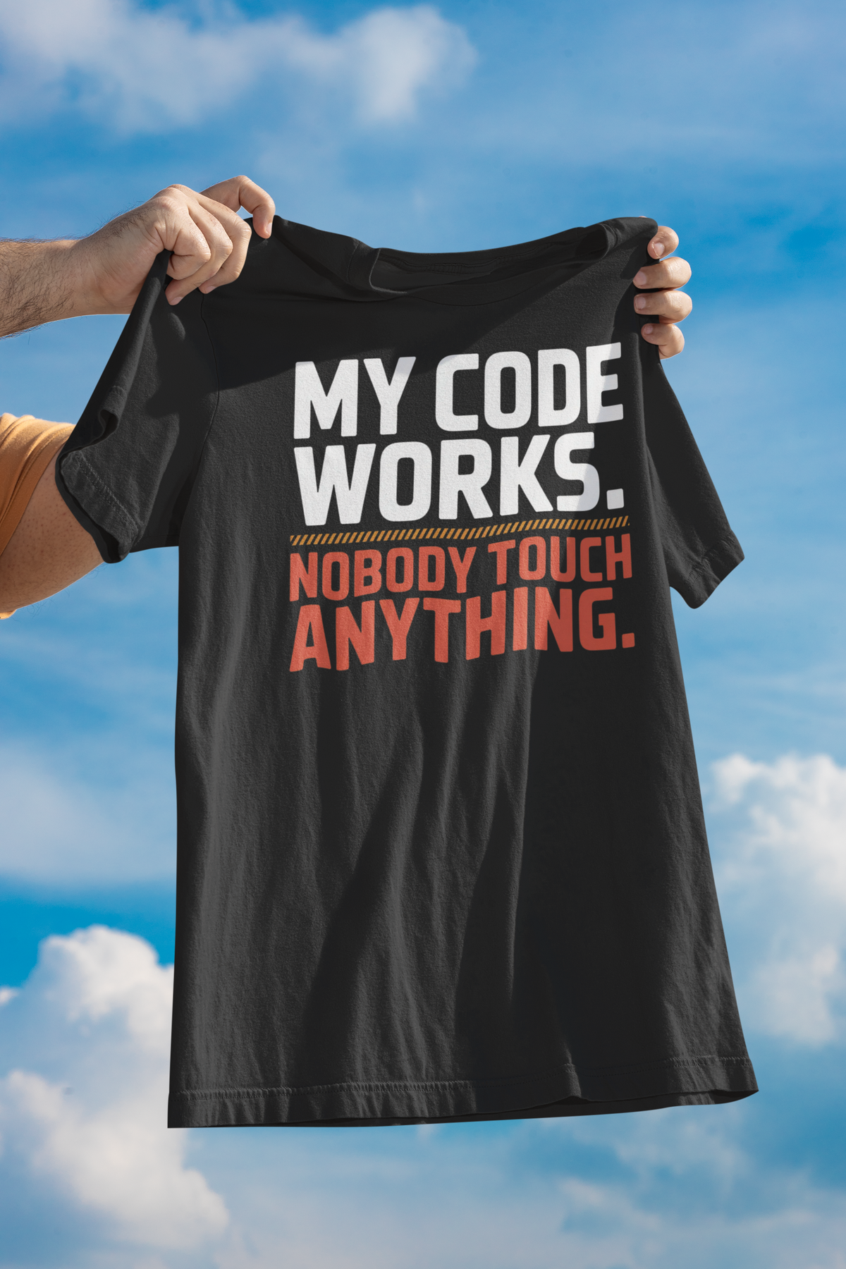 'My Code Works. Nobody Touch Anything.' black tee held up against sky, funny gift for developers