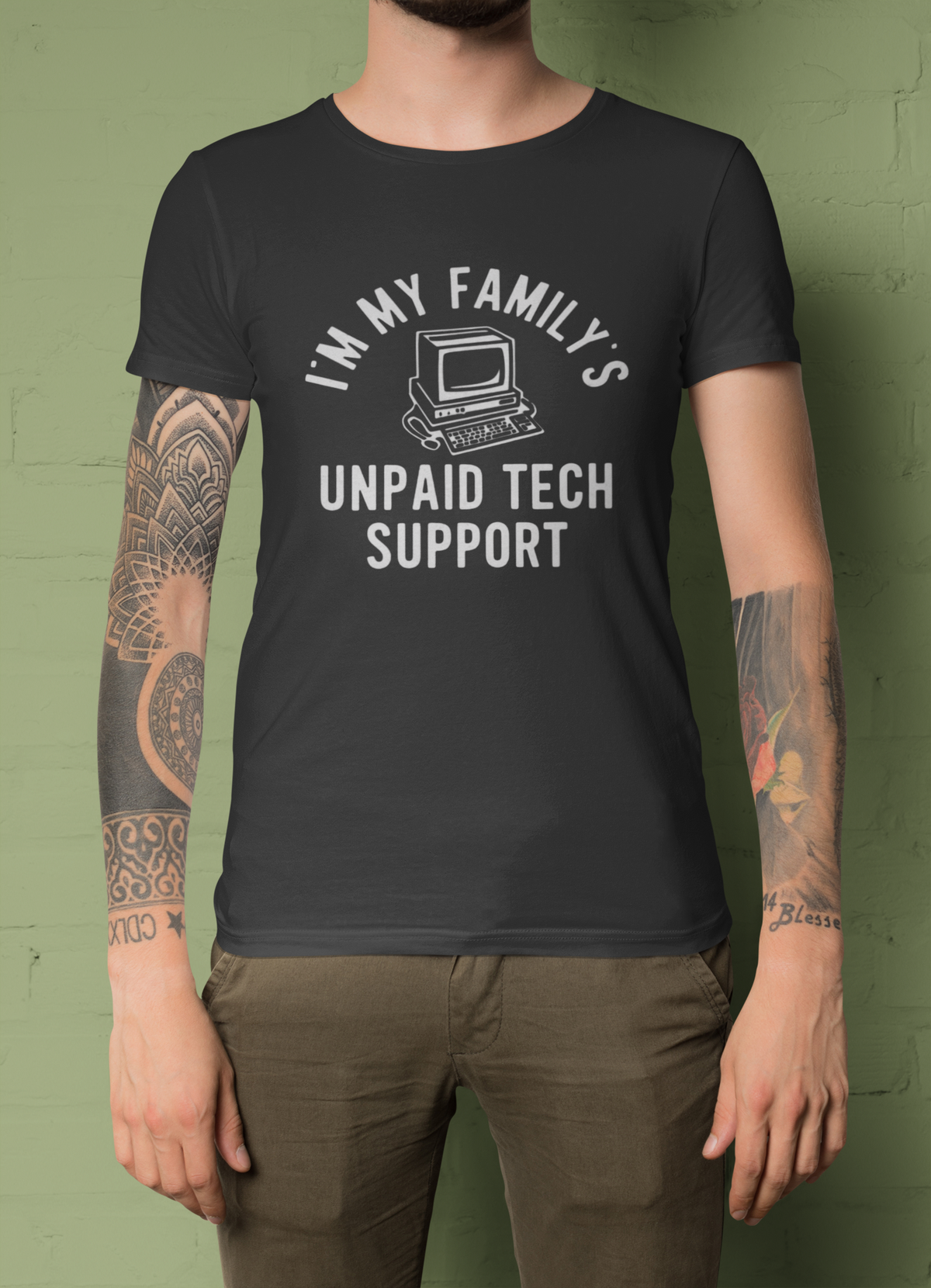 I'm My Family's Unpaid Tech Support charcoal t-shirt worn by a tattooed man front view, funny IT dad gift