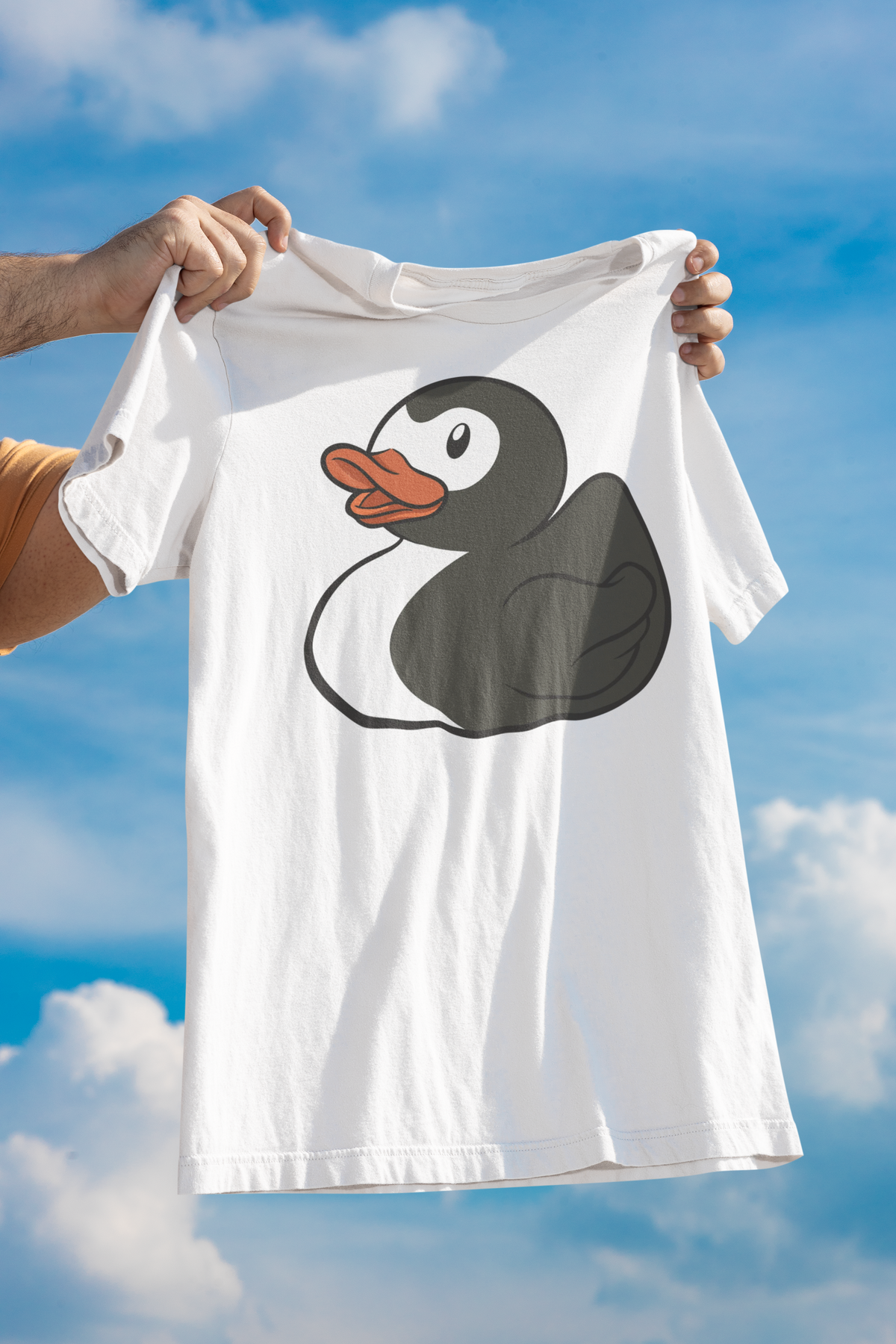 Super Duck t-shirt in white, held up outdoors against a cloudy sky backdrop, funny quirky animal gift