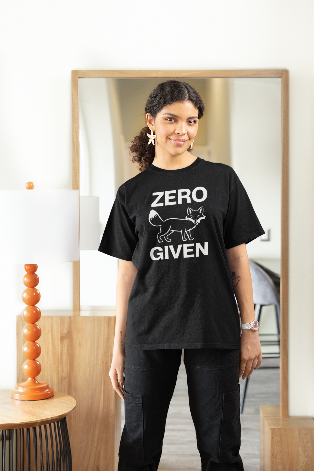 "Zero Fox Given" women's tee in black, woman modeling it at home, funny sarcastic gift shirt