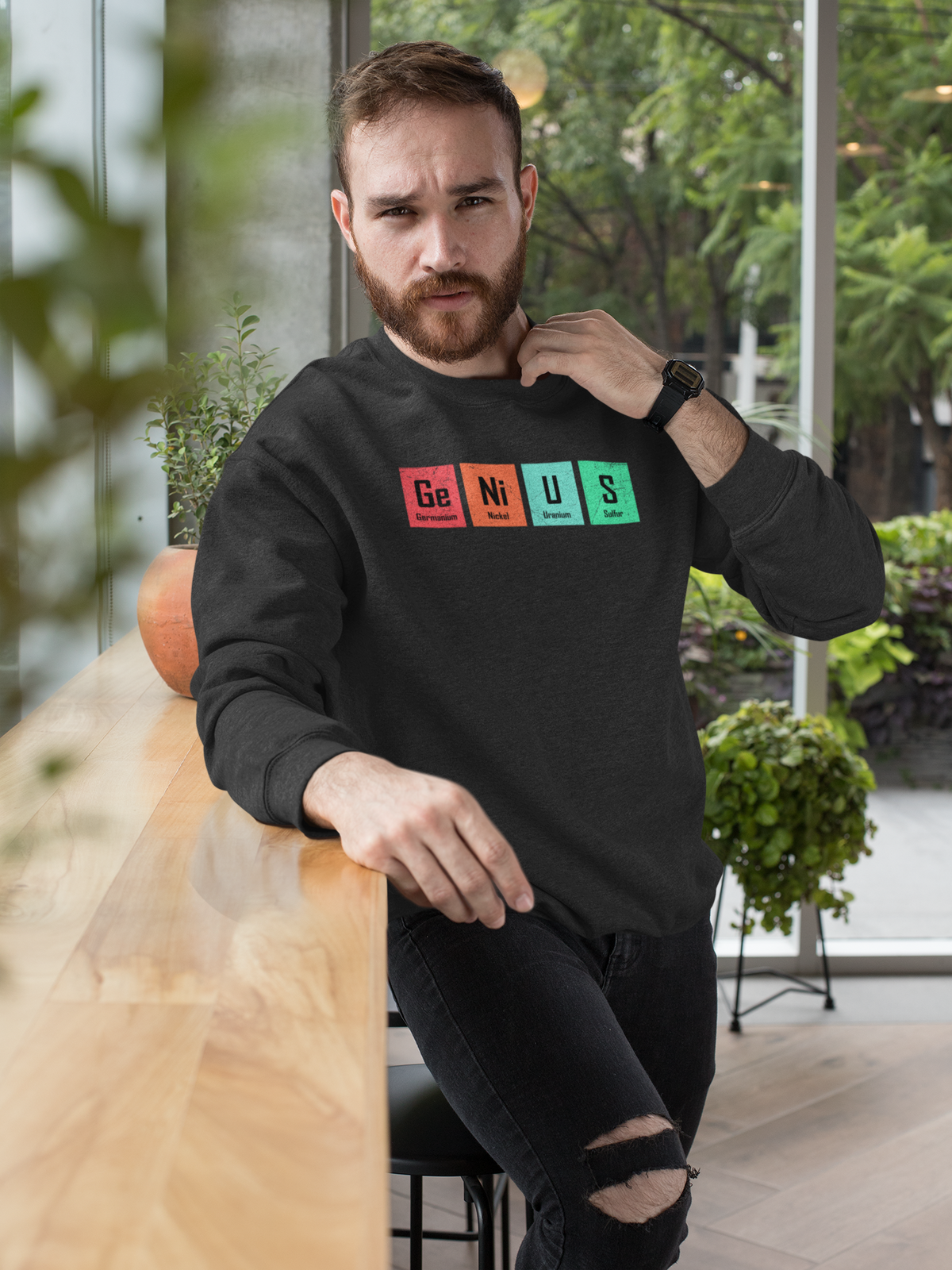 'Genius' periodic table pun sweatshirt in black, bearded man wearing it, funny chemistry gift