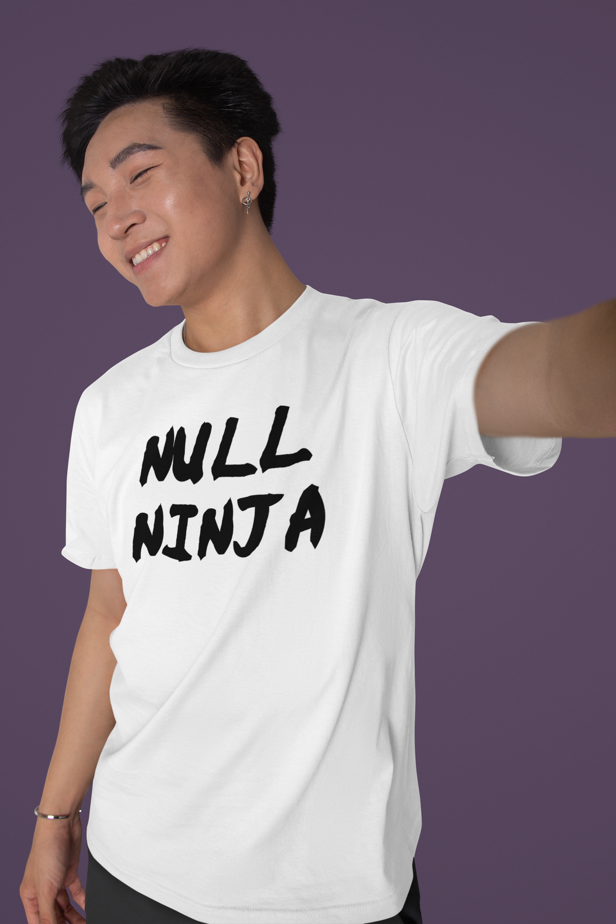 'Null Ninja' T-shirt in white, smiling man wearing it against a purple backdrop, developer gift tee