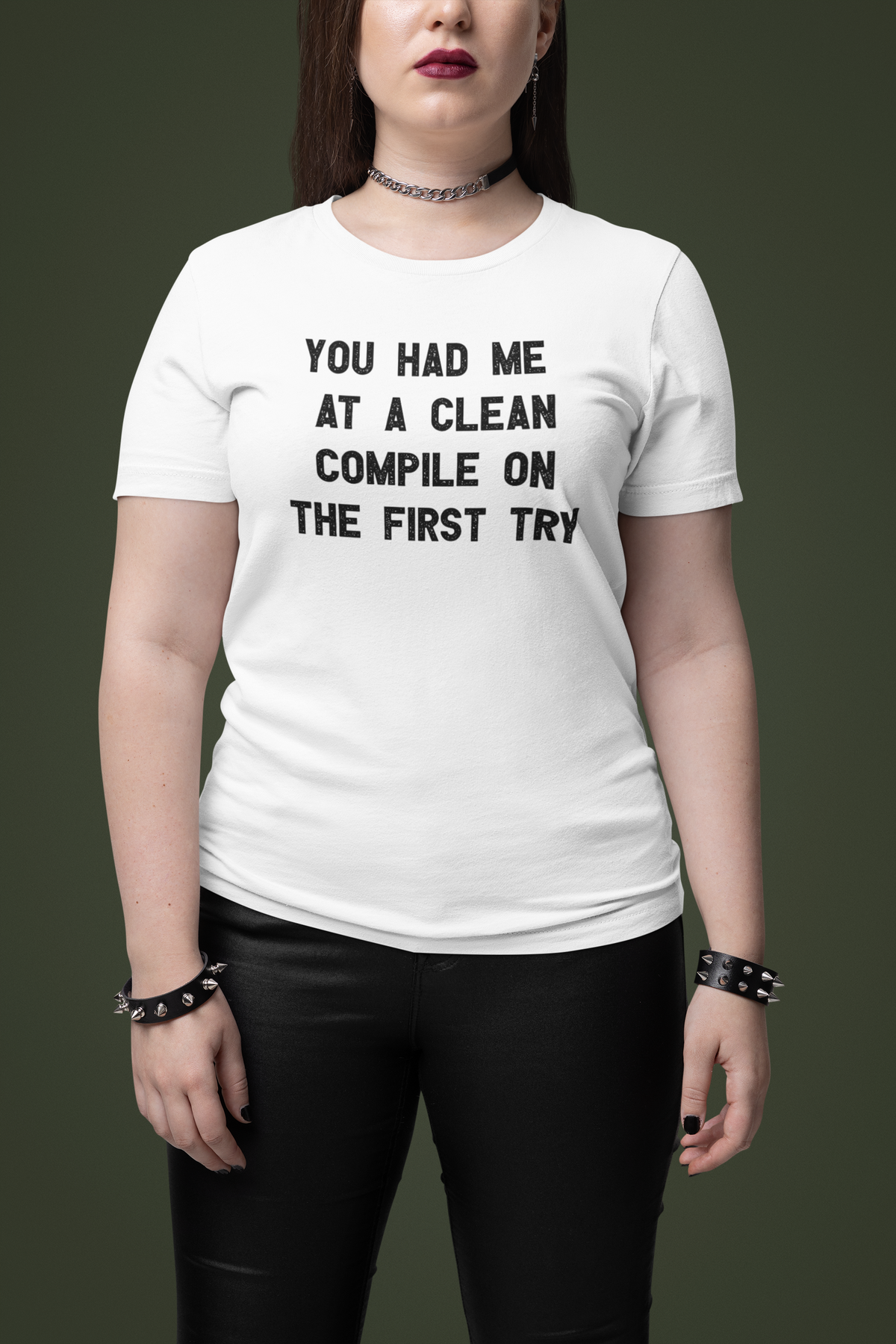 'You Had Me at a Clean Compile on the First Try' t-shirt in white, woman wearing it on a dark backdrop, funny coder pun gift