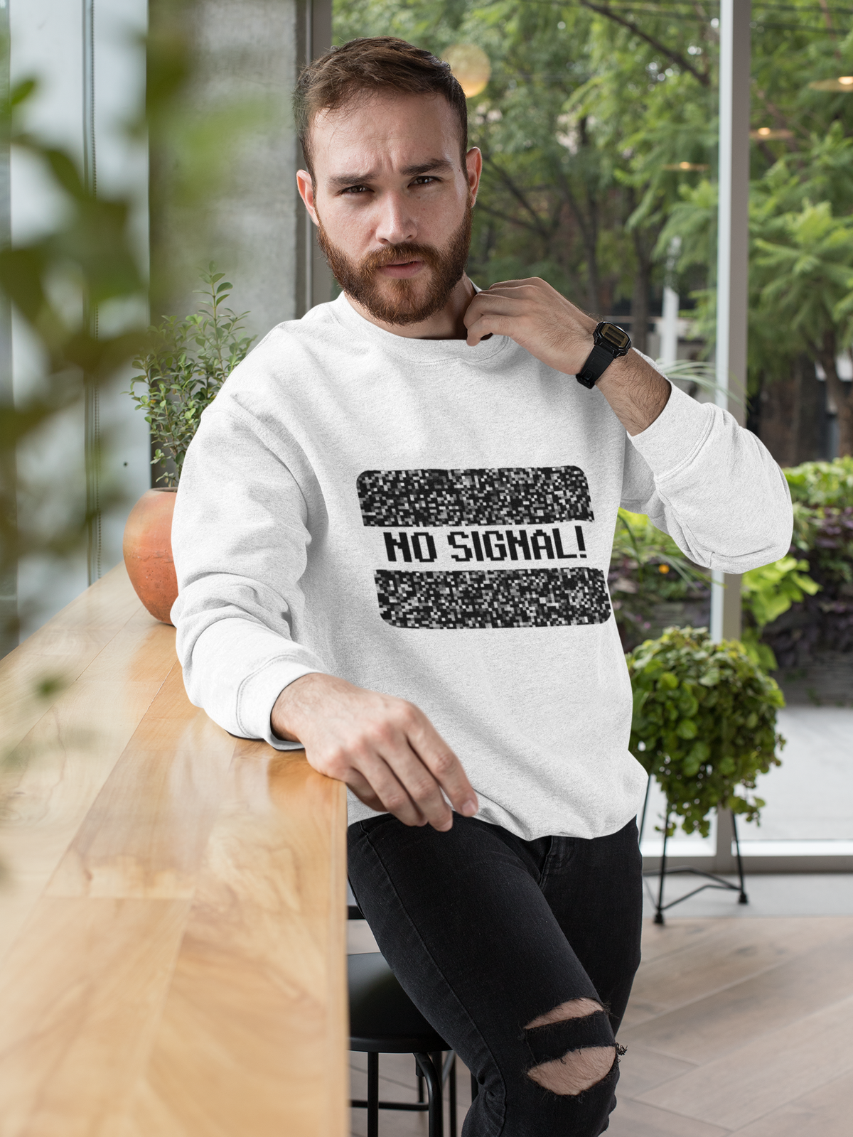 'No Signal' crewneck sweatshirt in white, bearded man wearing it outdoors on patio, retro TV lover gift