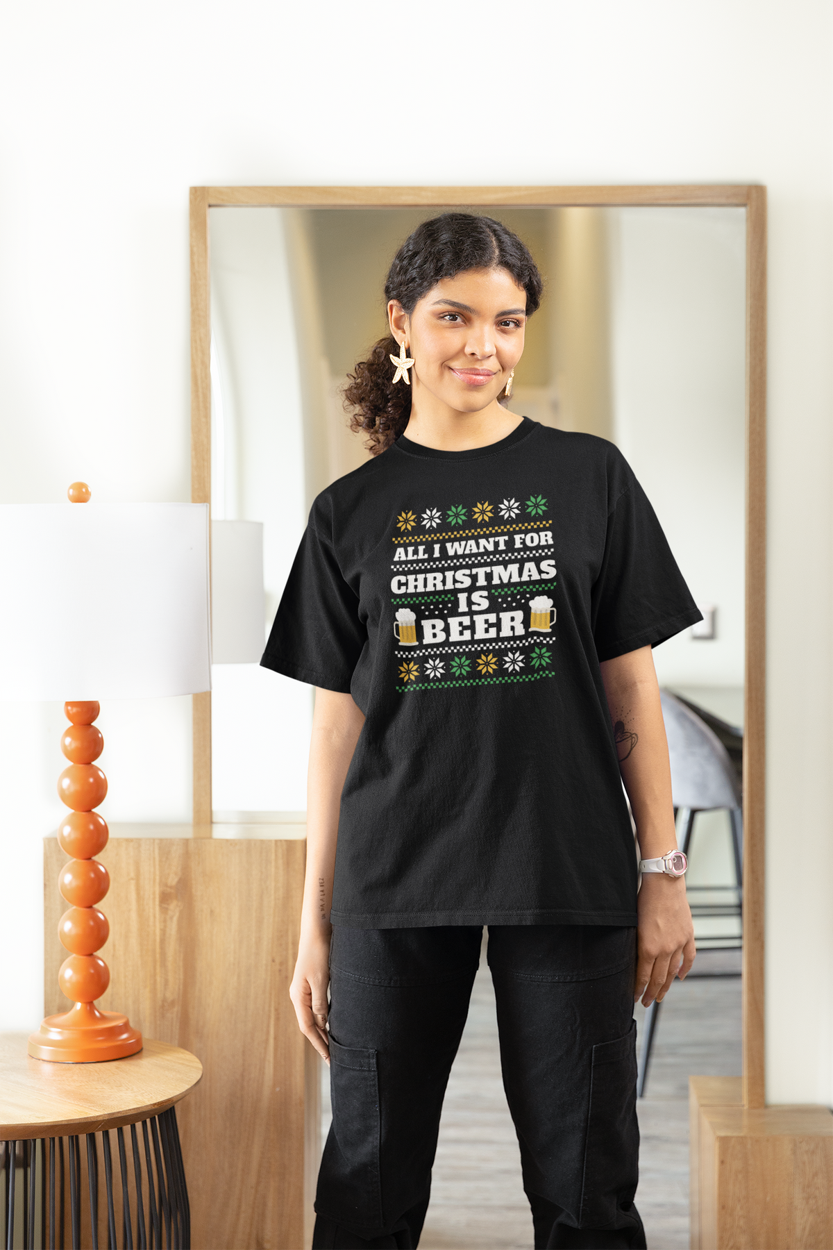 'All I Want For Christmas Is Beer' t-shirt in black, woman wearing it indoors near a mirror, funny gift