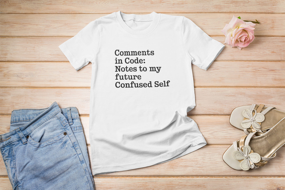 'Comments in Code' t-shirt in white, flat lay on rustic wood with flower, gift for developers
