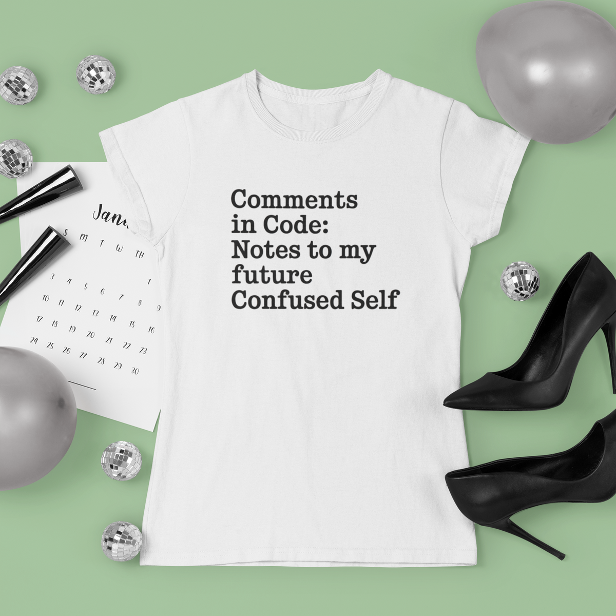 'Comments in Code' t-shirt in white, flat lay with heels and jewelry, funny programmer shirt
