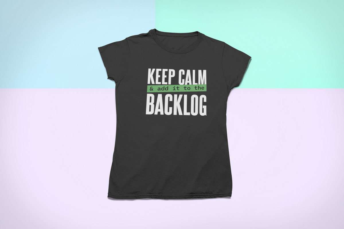 'Keep Calm and Add It to the Backlog' t-shirt in black, flat lay on a pastel gradient background, funny developer gift