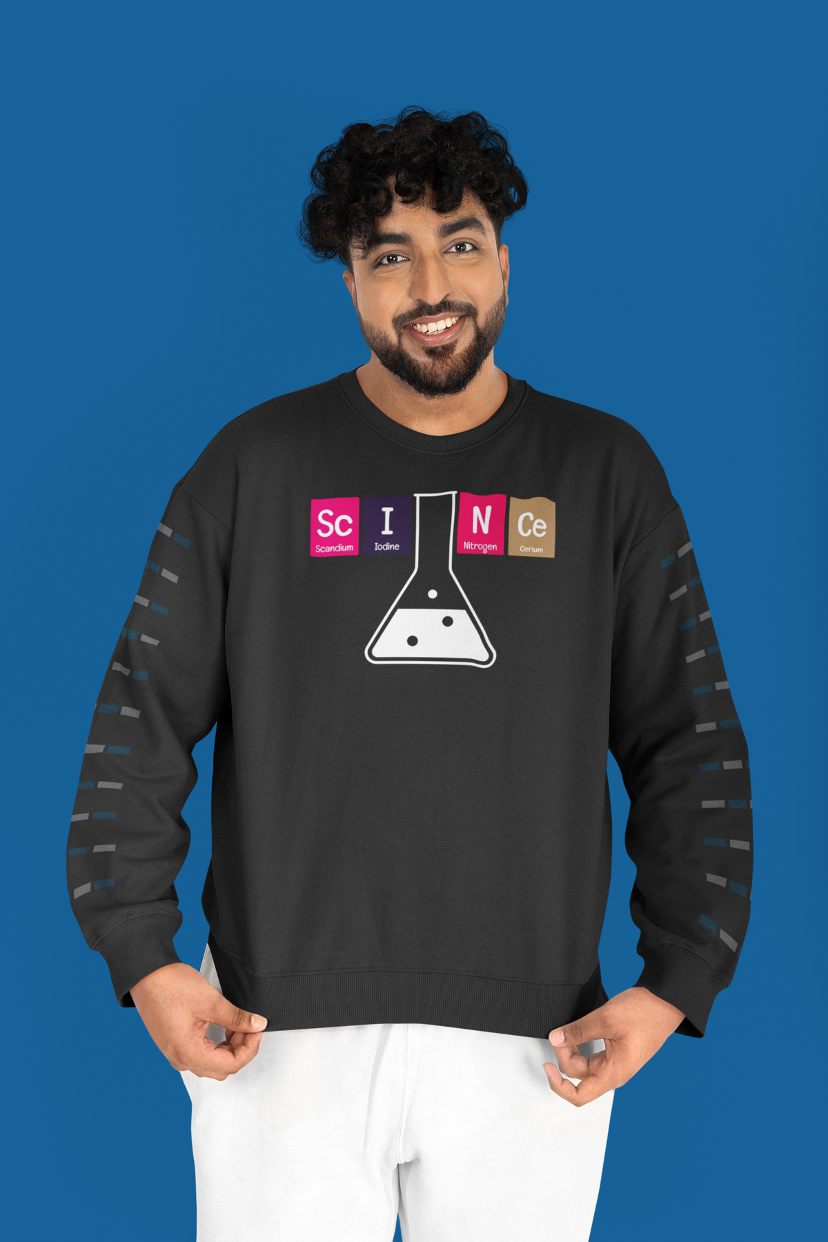 'Science' periodic table sweatshirt in navy with sleeve print, man wearing it against blue backdrop, science gift