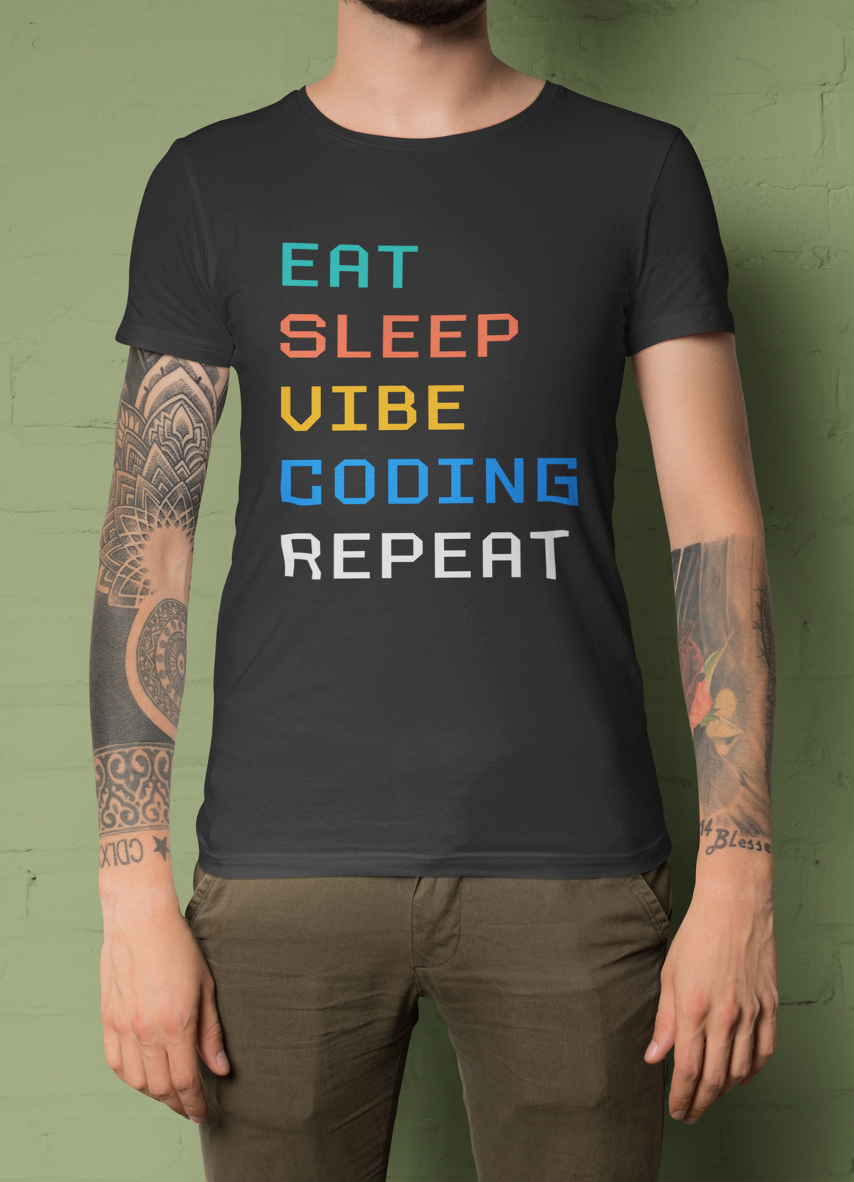 'Eat Sleep Vibe Coding Repeat' t-shirt in black, man wearing it on green background, funny gift for programmers
