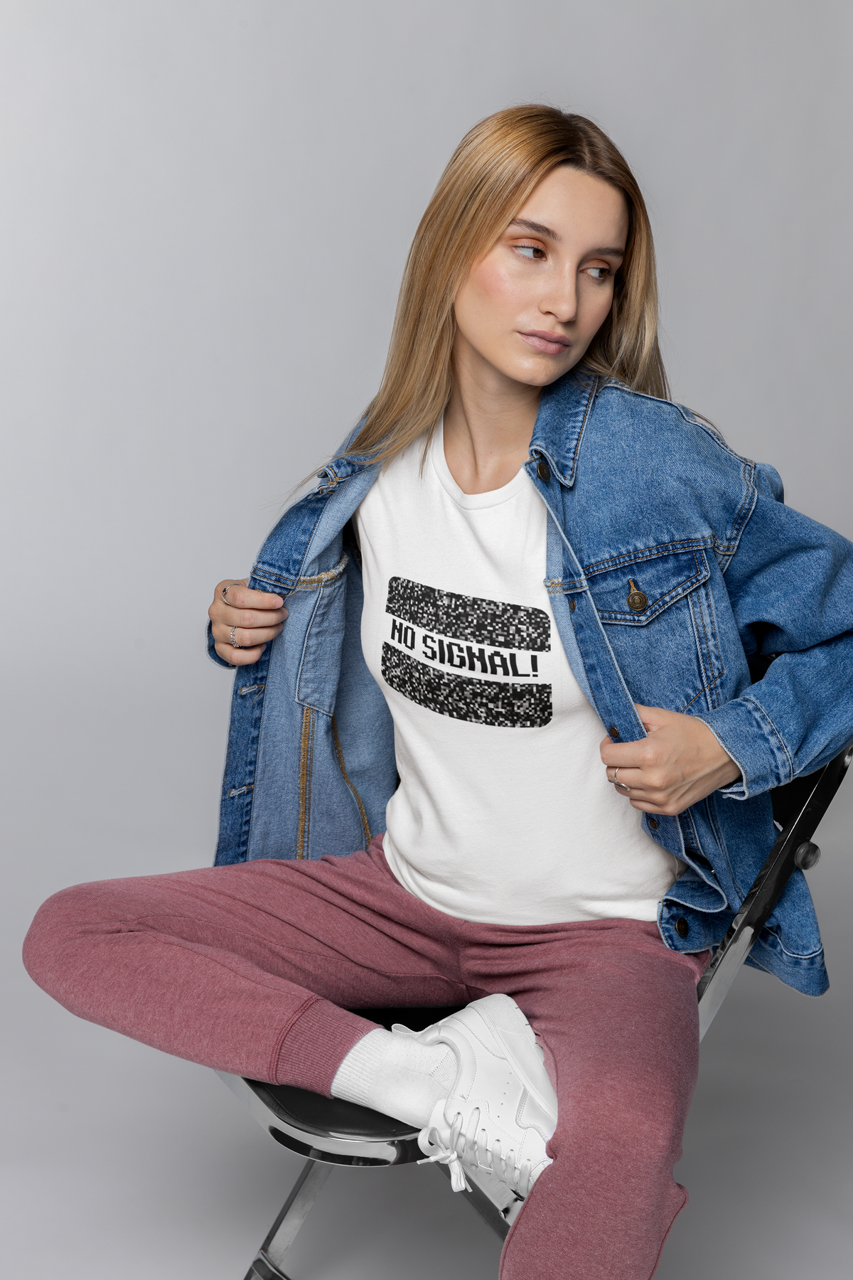 'No Signal' graphic t-shirt in white, woman wearing it with denim jacket, funny retro TV lover gift