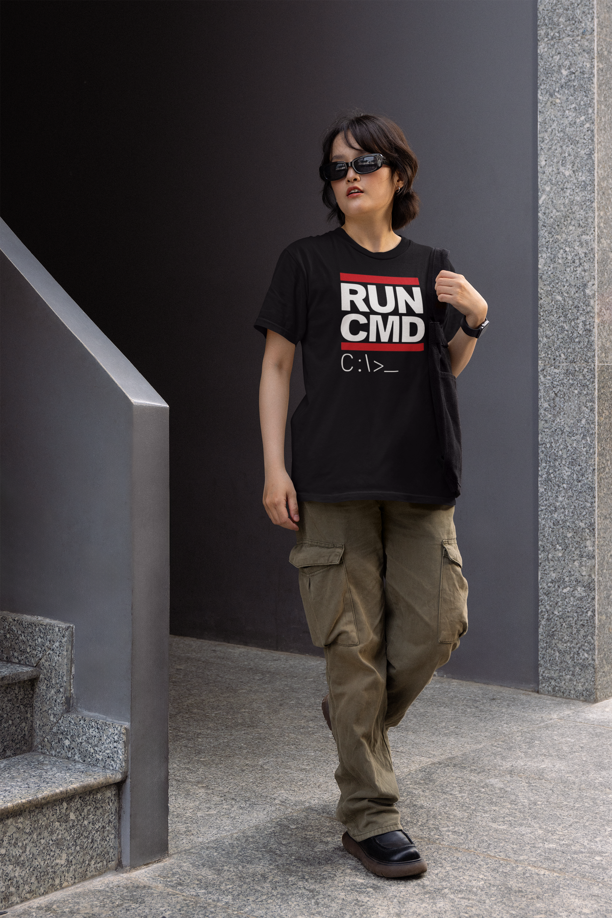 RUN CMD t-shirt in black, man wearing it outdoors on city stairs, funny coder pun gift