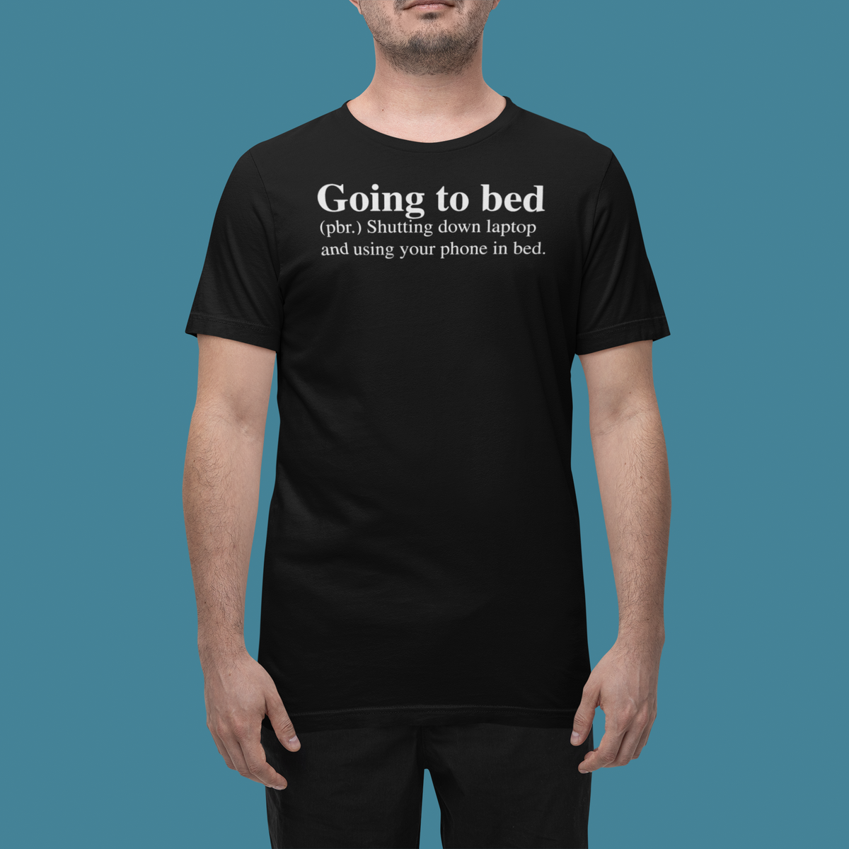 'Going to Bed' t-shirt in black, man wearing it in a studio, T-Shirt mockup, Geekpsters