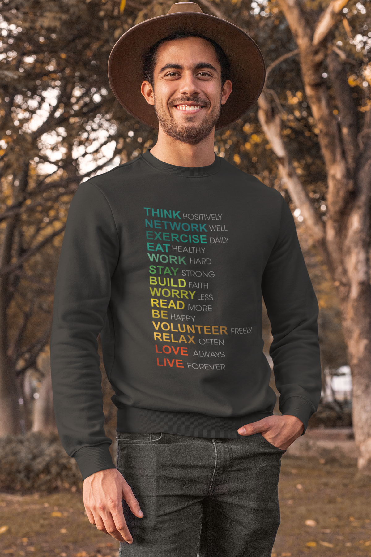 Think positive word list sweatshirt in black, man wearing a hat outdoors, motivational gift