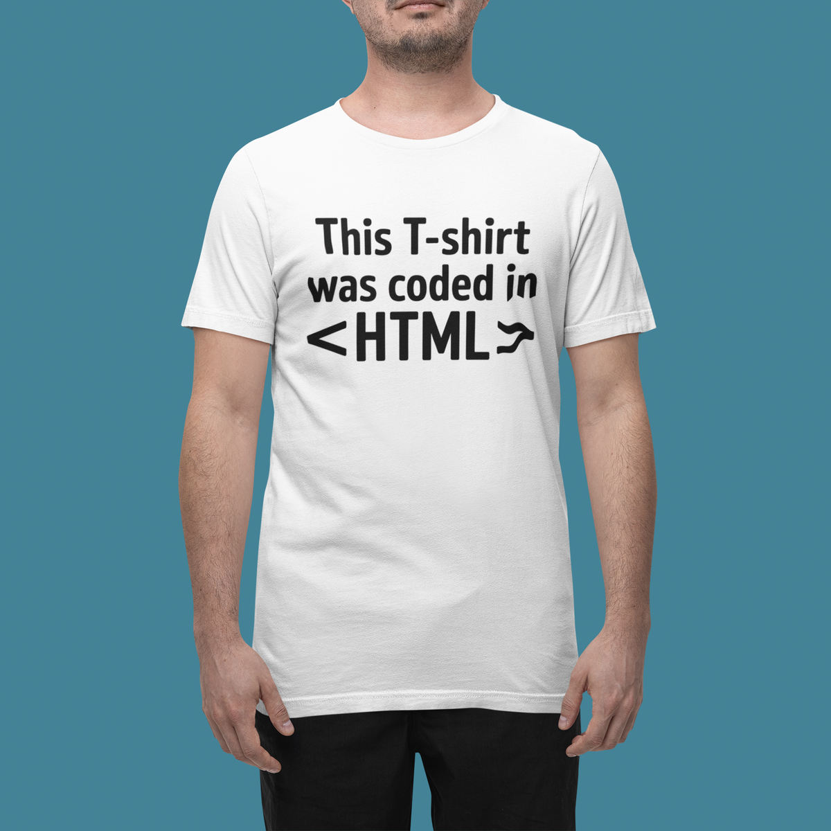 'This T-shirt was coded in HTML' white tee worn by man on blue background, funny gift for web developers