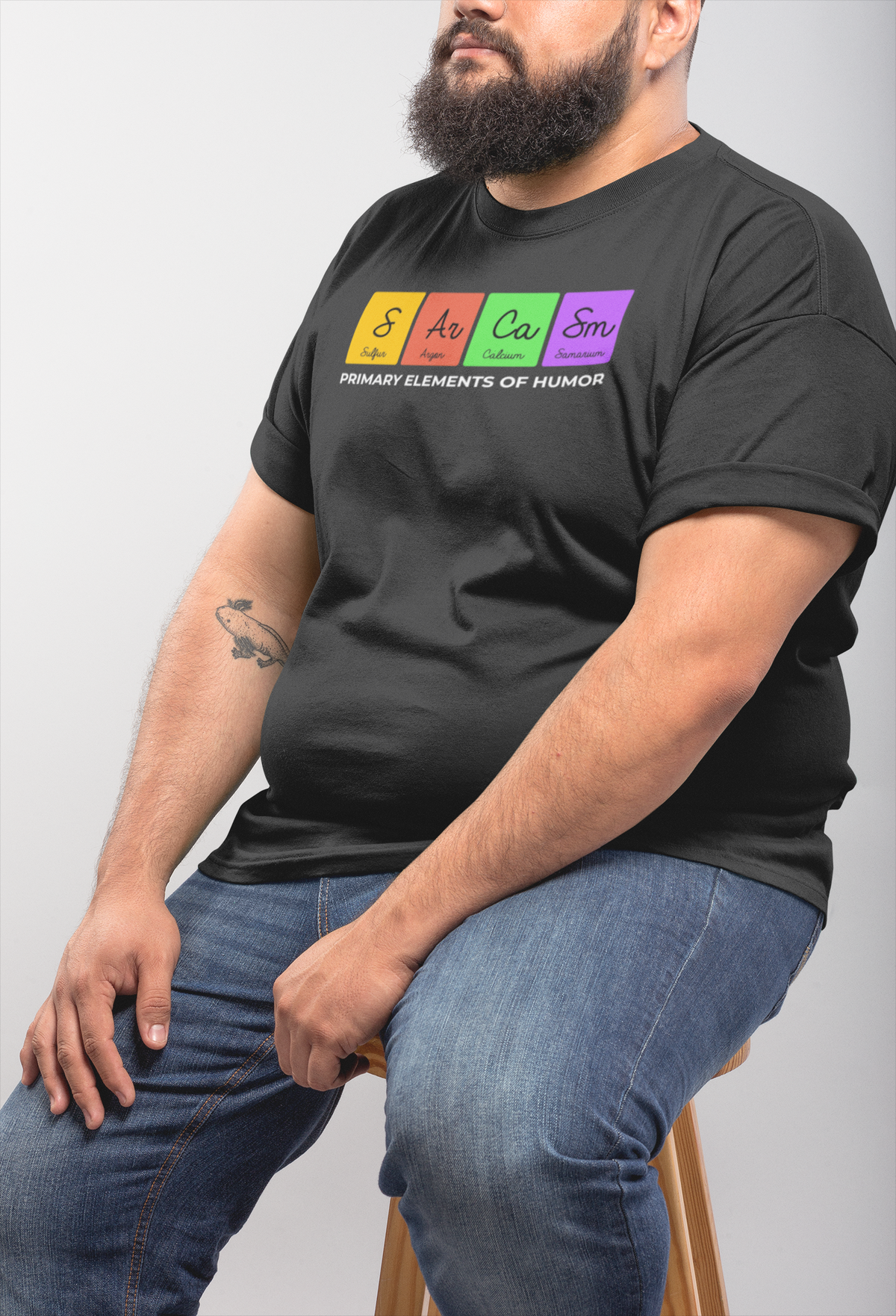 'Sarcasm, Primary Elements of Humor' periodic table t-shirt in black, bearded man sitting, funny science gift