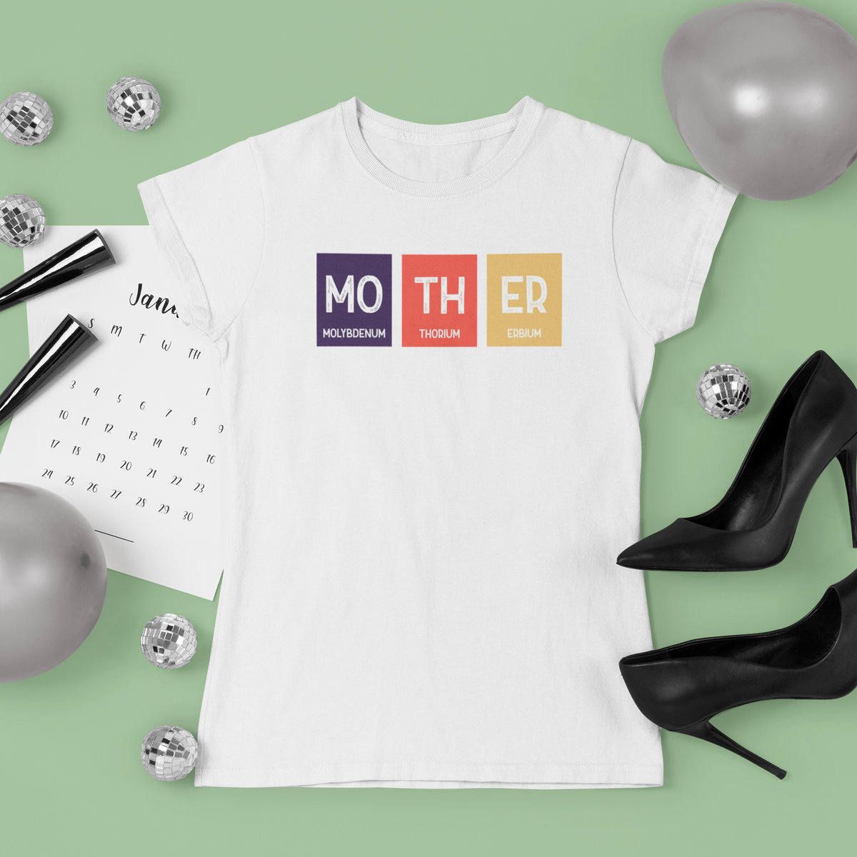 'Mother' periodic table t-shirt in white, flat lay styled with heels and confetti, Mother's Day gift