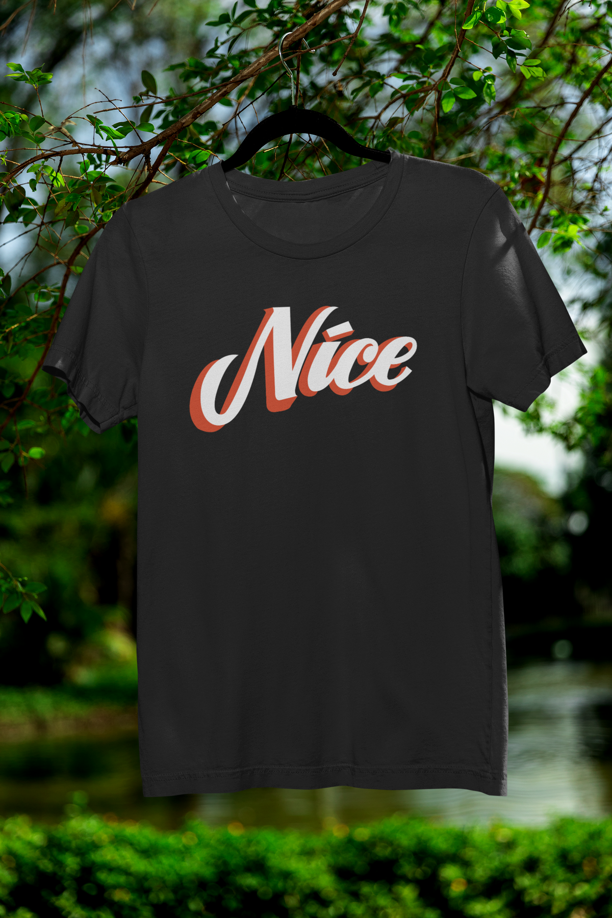 Nice script t-shirt in black, hanging outdoors on a hanger, funny sarcastic gift for coworkers