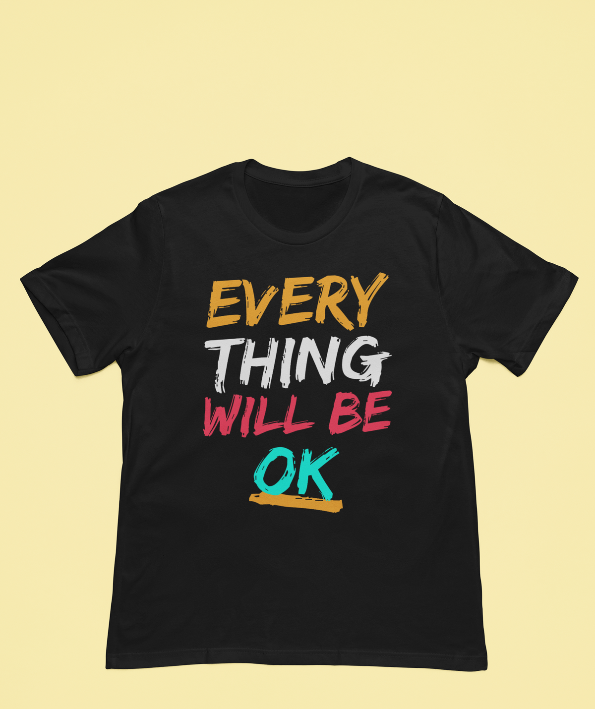 'Everything Will Be OK' T-shirt in black, styled flat lay on a yellow backdrop, motivational gift
