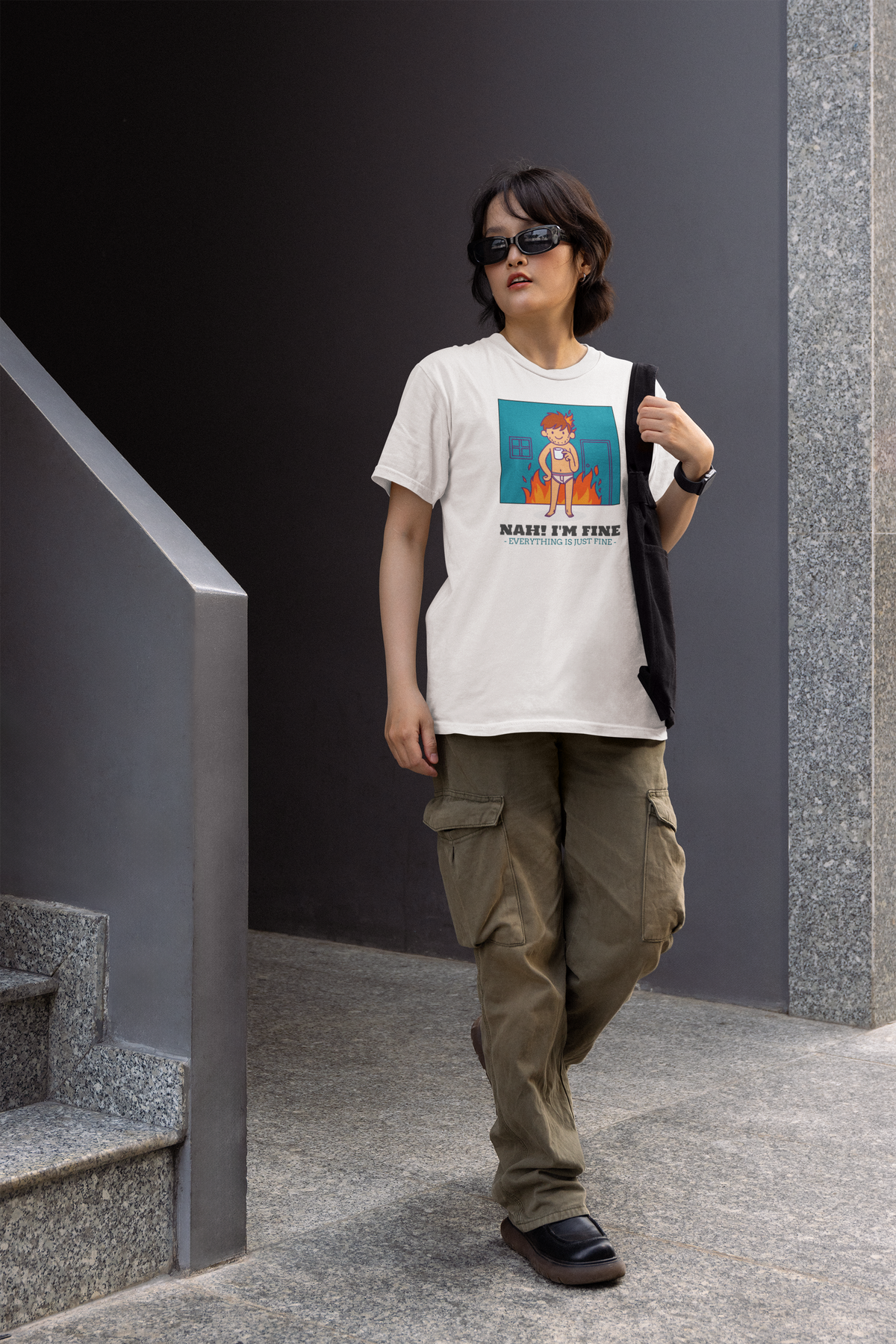 'Nah! I'm Fine' this is fine meme t-shirt in white, woman walking outdoors wearing it, funny sarcastic gift