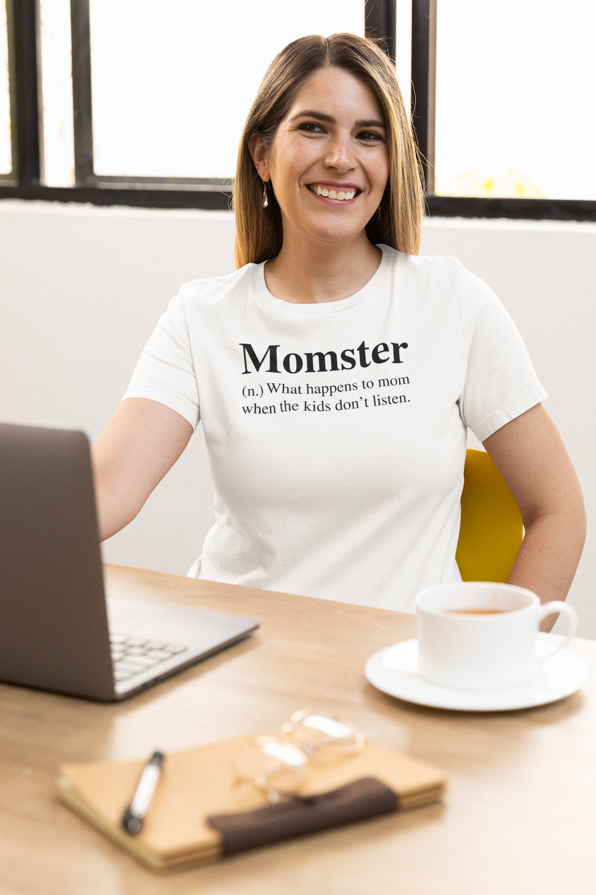 'Momster' definition T-shirt in white, smiling woman wearing it at a desk, funny mom gift tee
